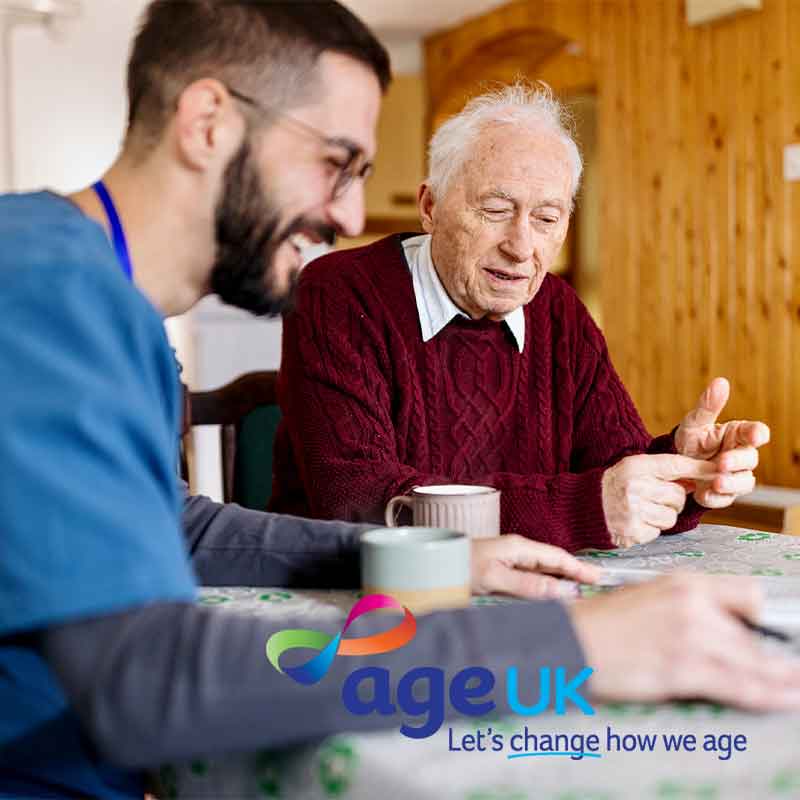Staff member helping elderly man