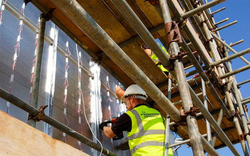 This is a man installing a sign